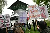 Demonstranten stehen mit Schildern bei einer Kundgebung vor der Justizvollzugsanstalt (JVA) Stadelheim, wo in einem Hochsicherheitssaal der Prozess vor dem Oberlandesgericht München gegen eine mutmaßliche Linksextremistin wegen Angriffen auf Neonazis in Budapest stattfindet.