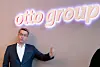 Konzernchef Alexander Birken vor dem Otto-Group-Logo