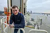Der zweite Offizier der „Acta Centaurus“, ein junger Mann steht auf einem Schiff