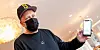 Der Hamburger Rapper Smudo demonstriert auf seinem Smartphone die App „Luca“.