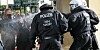 Einsatzkräfte der Polizei sprühen Reizmittel, um Teilnehmer einer aufgelösten Demonstration zurückzudrängen.