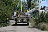 Ukrainische Soldaten fahren mit einem Militärfahrzeug.