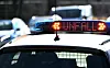 'Unfall' steht auf einem Polizeifahrzeug, das direkt neben der Unfallstelle hält.