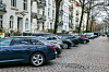 Reihe parkender Autos an einer Hamburger Straße vor weißen Altbauten und kahlen Bäumen