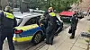 Polizisten führten eine Frau im Streifenwagen zur Wache ab.