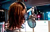 Eine Nachrichtensprecherin steht im Studio und spricht in ein Mikrofon.