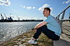 Sebastian Schonlau sitzt am Hamburger Hafen mit Blick auf das Wasser.