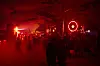 Besucher tanzen bei rotem Licht an der Dubstation auf dem Fusion-Festival in Mecklenburg-Vorpommern.
