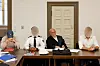 Drei Angeklagte sitzen mit Anwalt Walter Wellinghausen vor dem Gerichtssaal-Tisch in Hamburg.