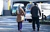 Links eine Frau und rechts ein Mann von hinten am Laufen auf einer Straße