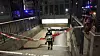 Einsatzkräfte sichern einen mit Absperrband gesperrten Treppenabgang in einem unterirdischen Zugang.