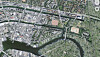 Luftaufnahme eines Stadtgebiets mit Fluss, Brücken, Straßen und Grünflächen.