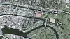 Luftaufnahme eines Stadtgebiets mit Fluss, Brücken, Straßen und Grünflächen.