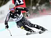 TJ Lanning fährt in tiefer Kurvenlage die Abfahrt in Lake Louise mit Startnummer 29.