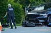 Polizei an einer Unfallstelle mit beschädigtem SUV und verstreuten Trümmern auf der Straße.