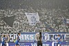 Dicht gefüllte Fantribüne mit Fahnen und Bannern beim Spiel Dynamo Dresden gegen den 1. FC Magdeburg.