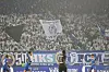 Dicht gefüllte Fantribüne mit Fahnen und Bannern beim Spiel Dynamo Dresden gegen den 1. FC Magdeburg.