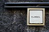 Beschriftetes Klingelschild „Klingel“ an einer verwitterten Hauswand in Berlin.