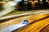 Auto auf der A100 mit starkem Wischeffekt bei Nacht.
