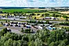 Mehrere Lkw stehen auf einem Rastplatz an der A12 in Brandenburg, aufgenommen aus der Luft.