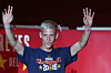 Dani Olmo mit erhobenen Armen vor einer roten Bühne bei den Feierlichkeiten auf der Plaza de Cibeles in Madrid.