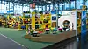 Messestand von rolly toys mit Kindertraktoren, Kipplastern, Schubkarren und Absperrelementen in Nürnberg.