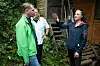 Michael Kretschmer spricht mit Verena Leister vor einer zerstörten Holzhütte im Amselgrund.