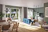 Helles Wohnzimmer mit blauem Sofa, offenem Terrassenzugang und Gartenausblick.