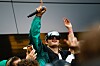 Ski Aggu rappt mit Mikrofon und Sonnenbrille vor Fans auf einem Lidl-Parkplatz in Neukölln.