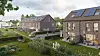 Moderne Backsteinhäuser mit Solarmodulen in einer begrünten Wohnsiedlung