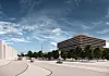 Moderner Bürokomplex mit Bäumen und breitem Stadtplatz unter blau bewölktem Himmel