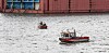 Mit mehreren Booten sucht die Hamburger Feuerwehr die Elbe nahe der Sietas Werft ab.