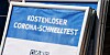 Ein Schild mit der Aufschrift „Kostenloser Corona-Schnelltest“ steht vor einem Testzentrum.