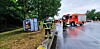 Feuerwehrleute richten den umgekippten Bus wieder auf.