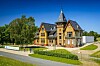 Eine alte Backstein-Villa mit Türmchen bei Sonnenschein