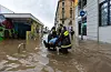 Rettungskräfte tragen eine Frau, nachdem der Fluss Seveso über die Ufer getreten ist und die Stadt überschwemmt.