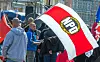 Teilnehmer einer Kundgebung der NPD in der Innenstadt von Schwerin halten Fahnen mit dem Parteilogo in der Hand. (Archivbild)